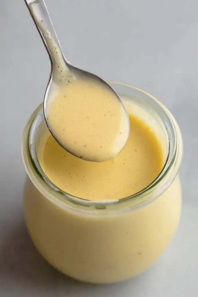 bernaise sauce in a jar with a spoon