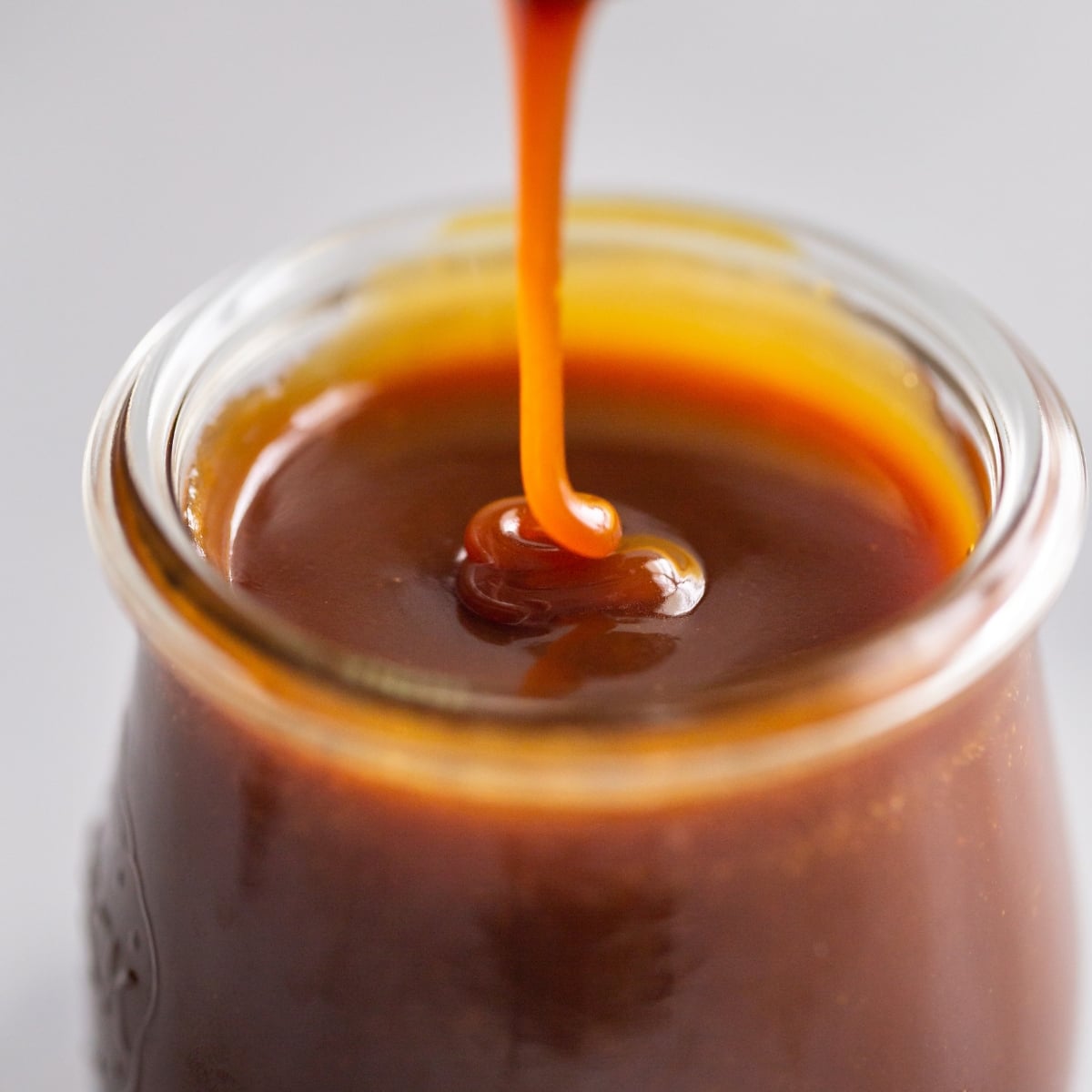 Easy Homemade Caramel Sauce drizzled in jar