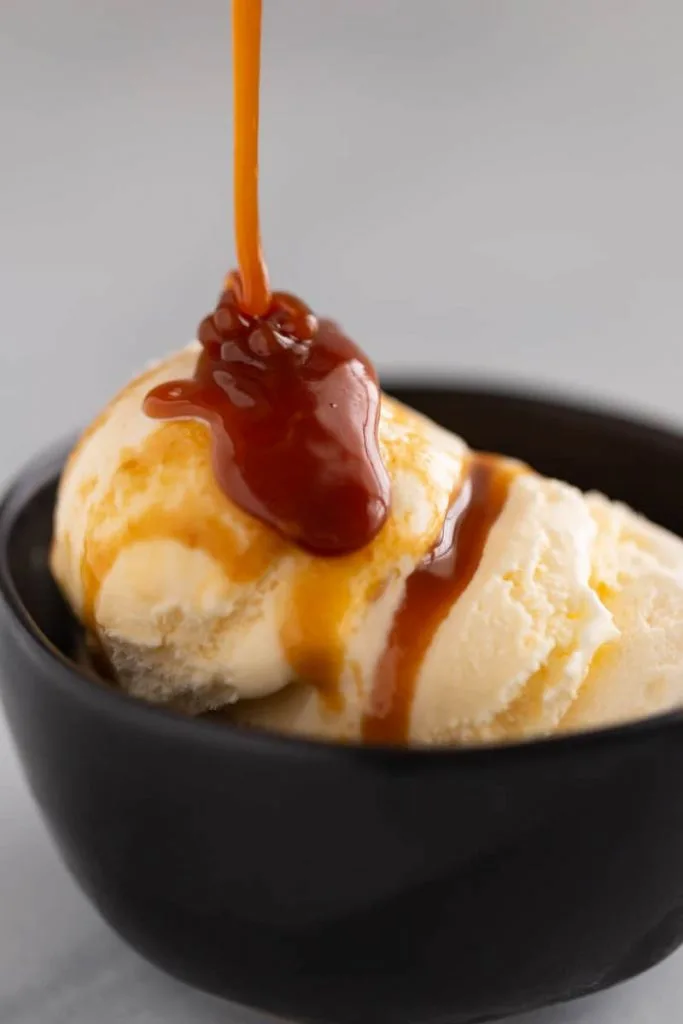 Easy Caramel Sauce drizzled over ice cream
