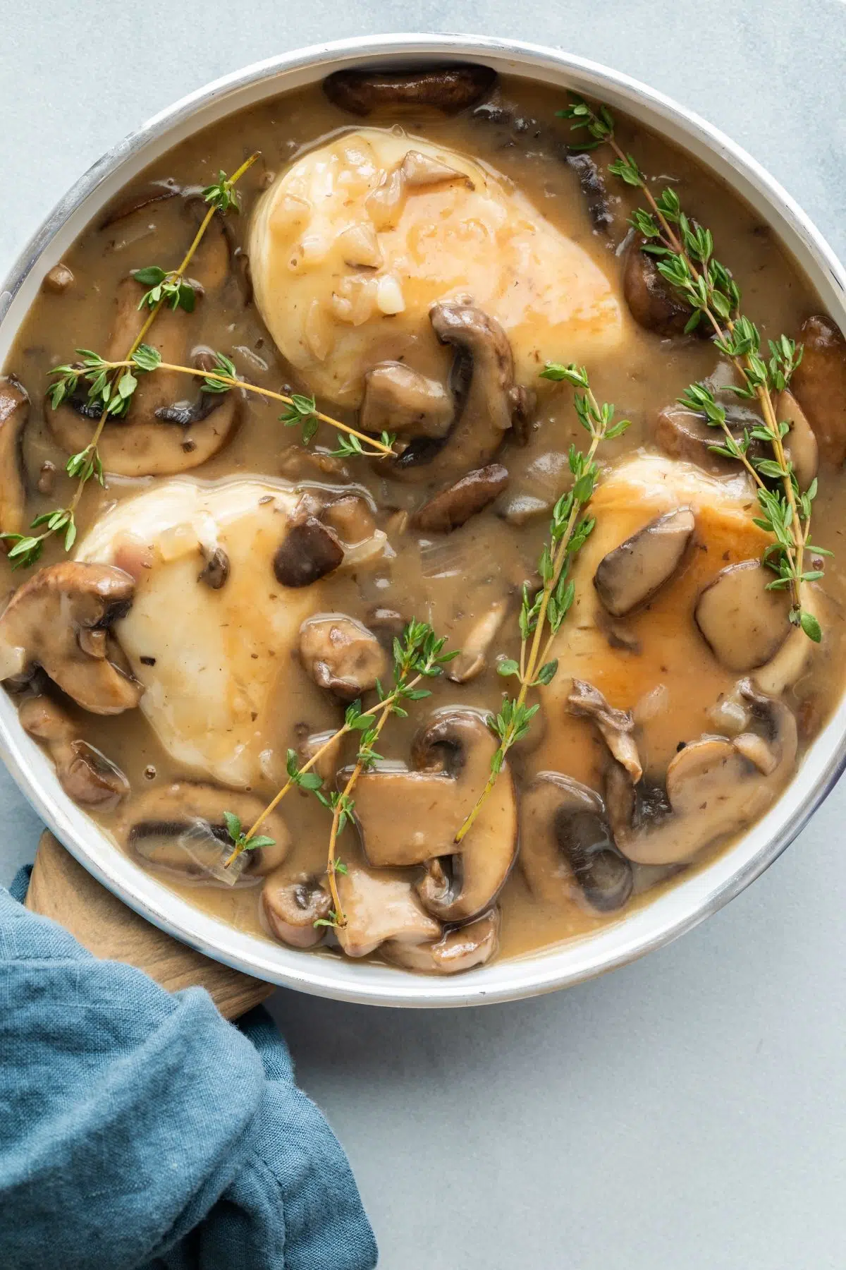 overhead of chicken marsala in white pan