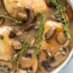chicken marsala sauce in pan with chicken breasts