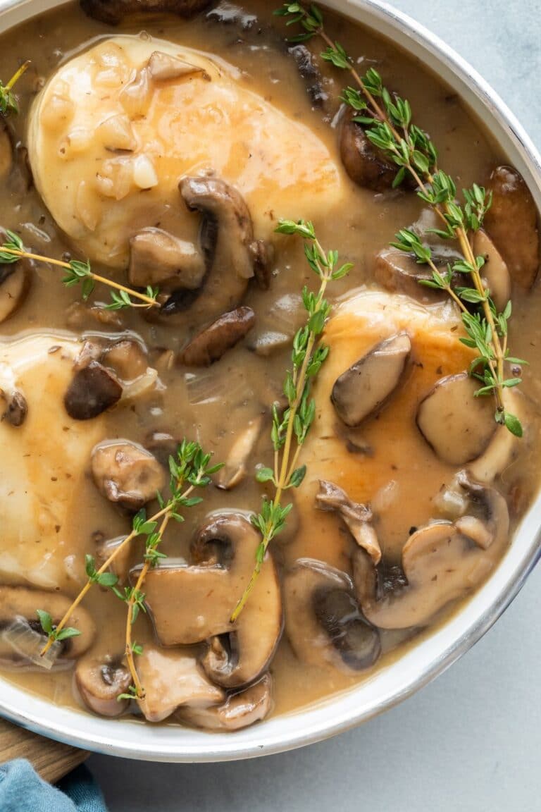 chicken marsala sauce in pan with chicken breasts
