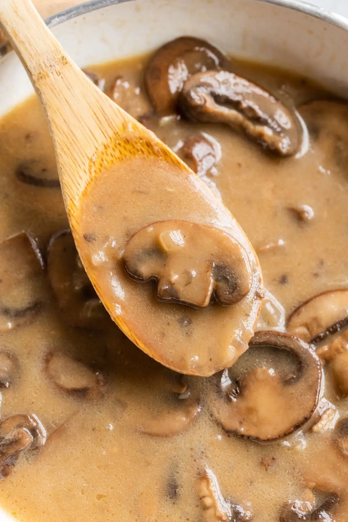 chicken marsala sauce on wooden spoon