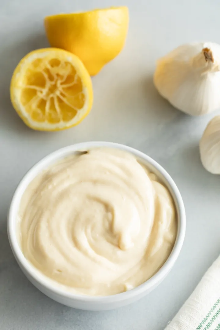 overhead of roasted garlic aioli in a white bowl