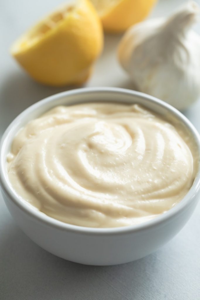 close up of roasted garlic aioli sauce in white bowl