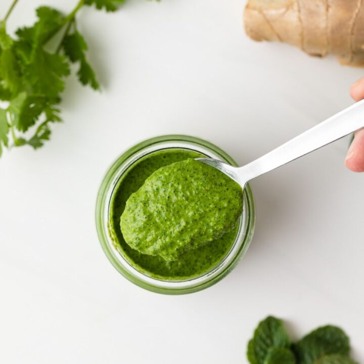 Overhead view of cilantro mint sauce on a spoon.