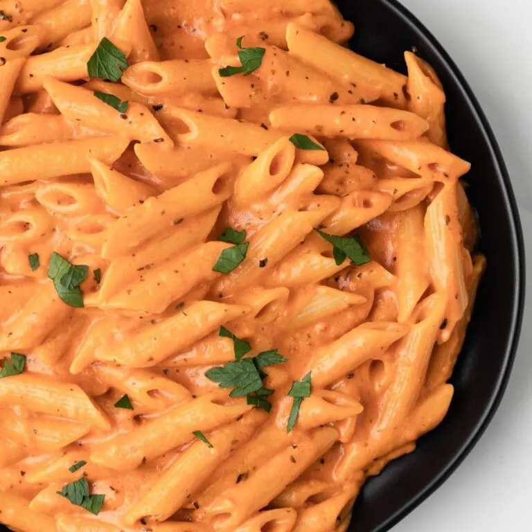 Overhead of pasta coated in pink sauce.