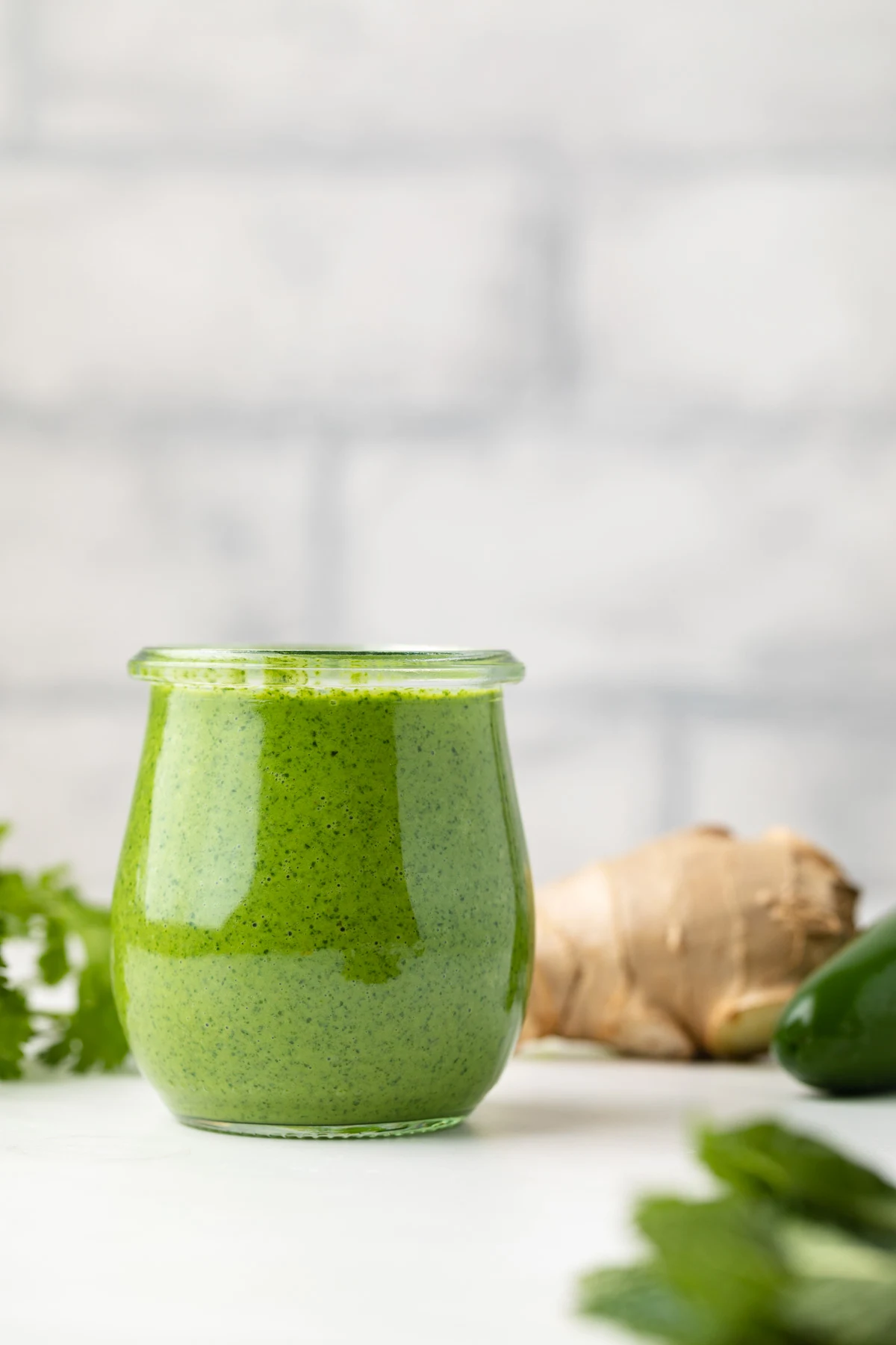 Side view of mint sauce in a jar.