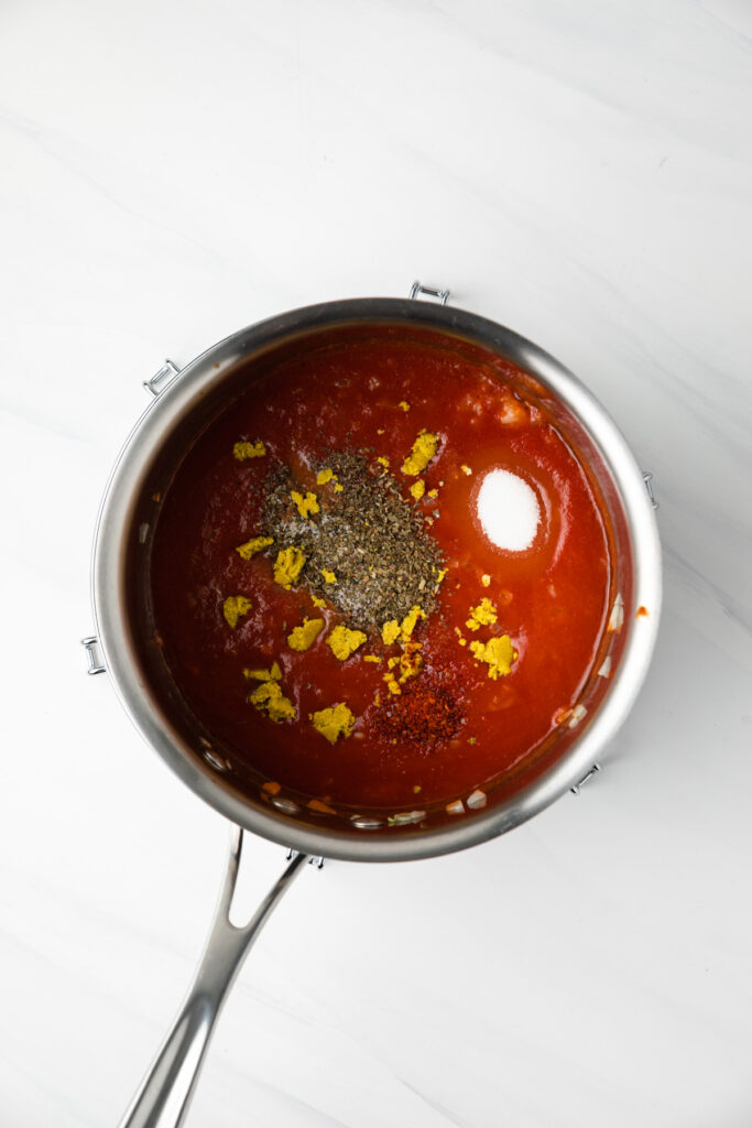 Ingredients for pasta sauce in a pot.