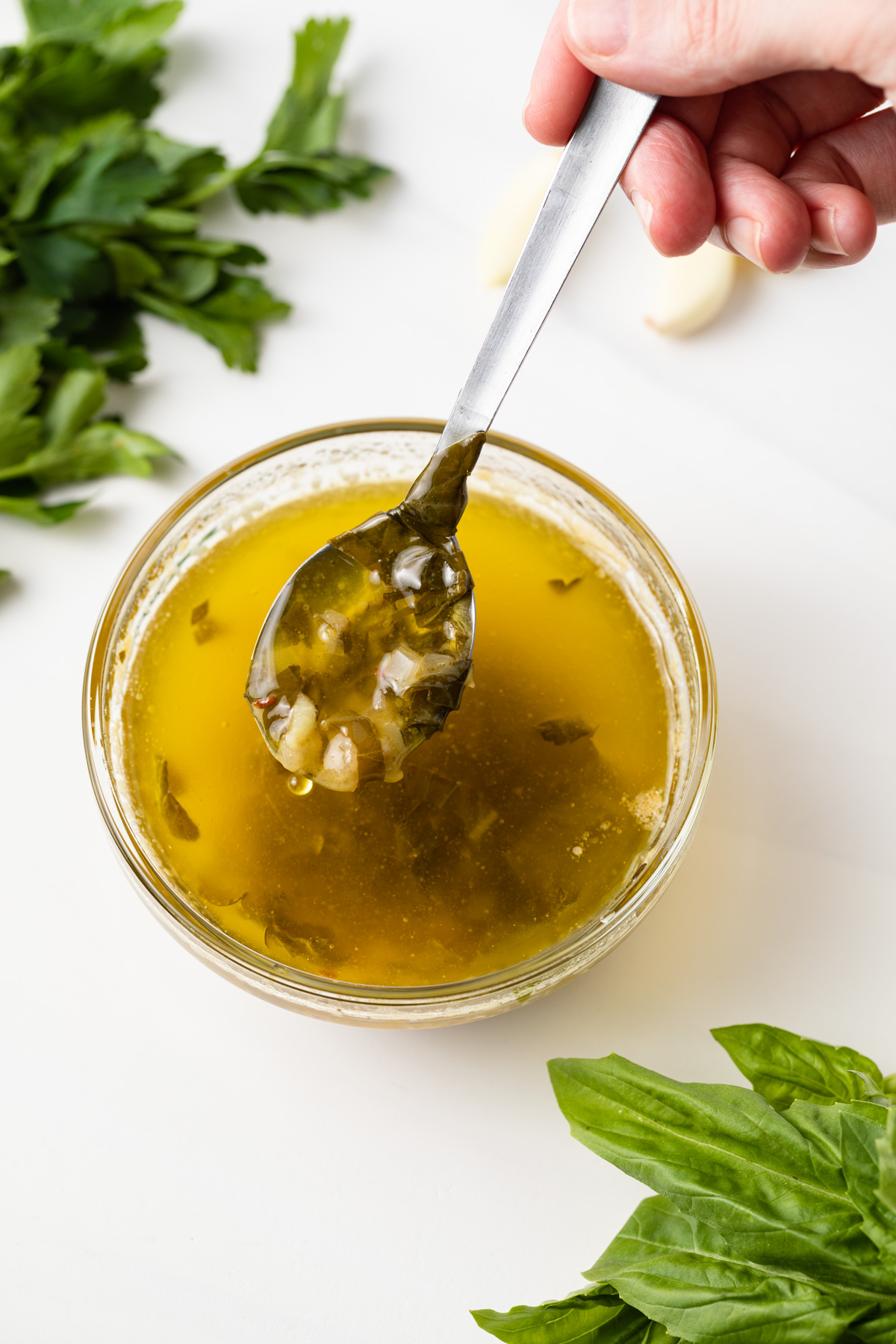 Amogio sauce in glass bowl with spoon.