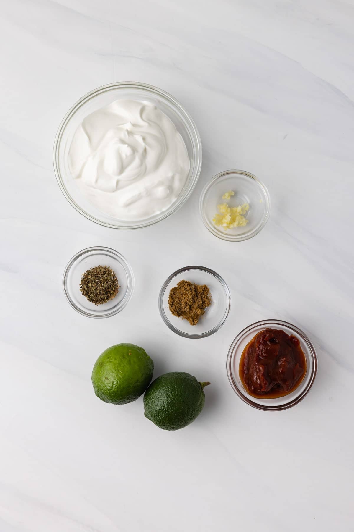 Ingredients for burrito sauce laid out in bowls.