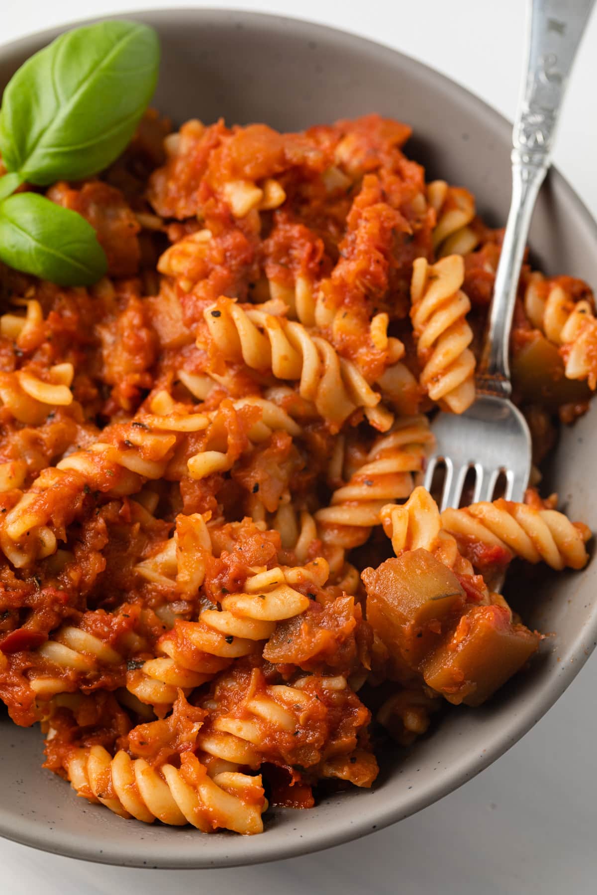 Close up of eggplant tomato sauce and pasta.
