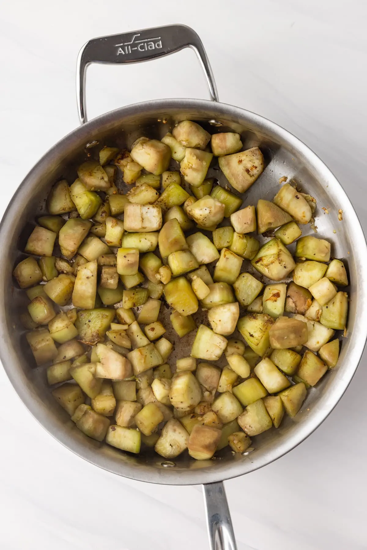 Cooked eggplant in frypan.