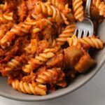 Close up of eggplant tomato sauce and pasta.