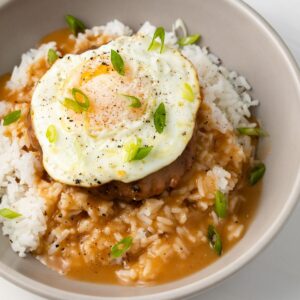 Rice, beef patty, egg, and Hawaiian brown gravy in a bowl.