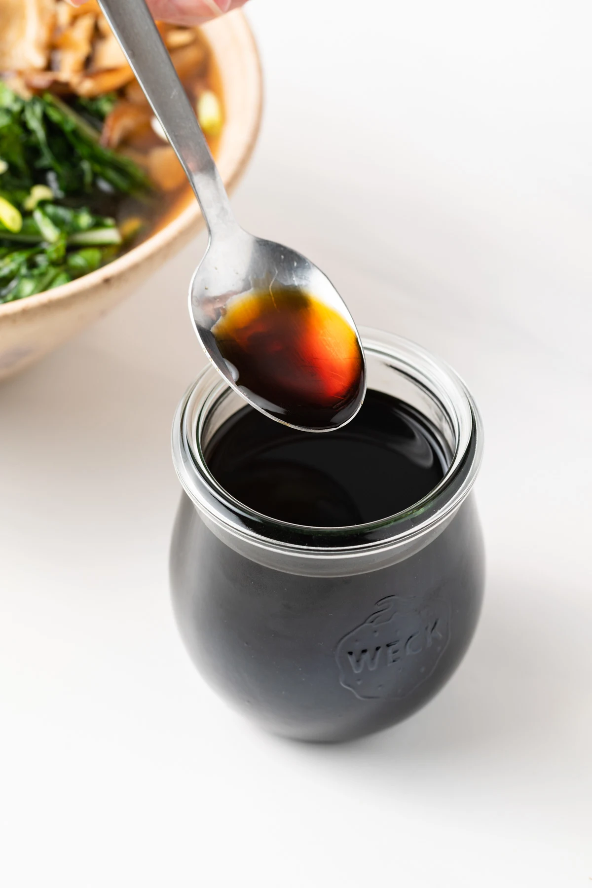 Jar of sukiyaki with a spoon.