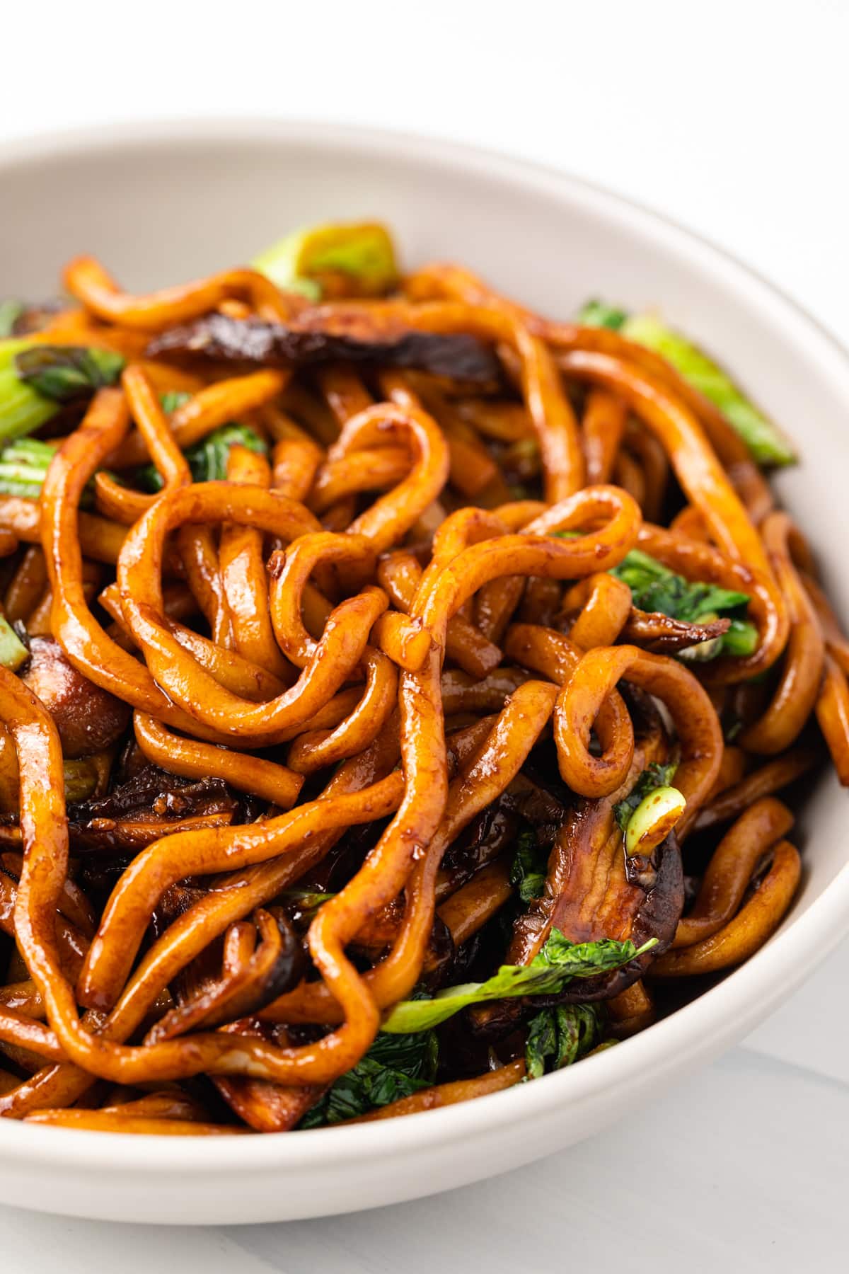 close up of stir fried udon and sauce.