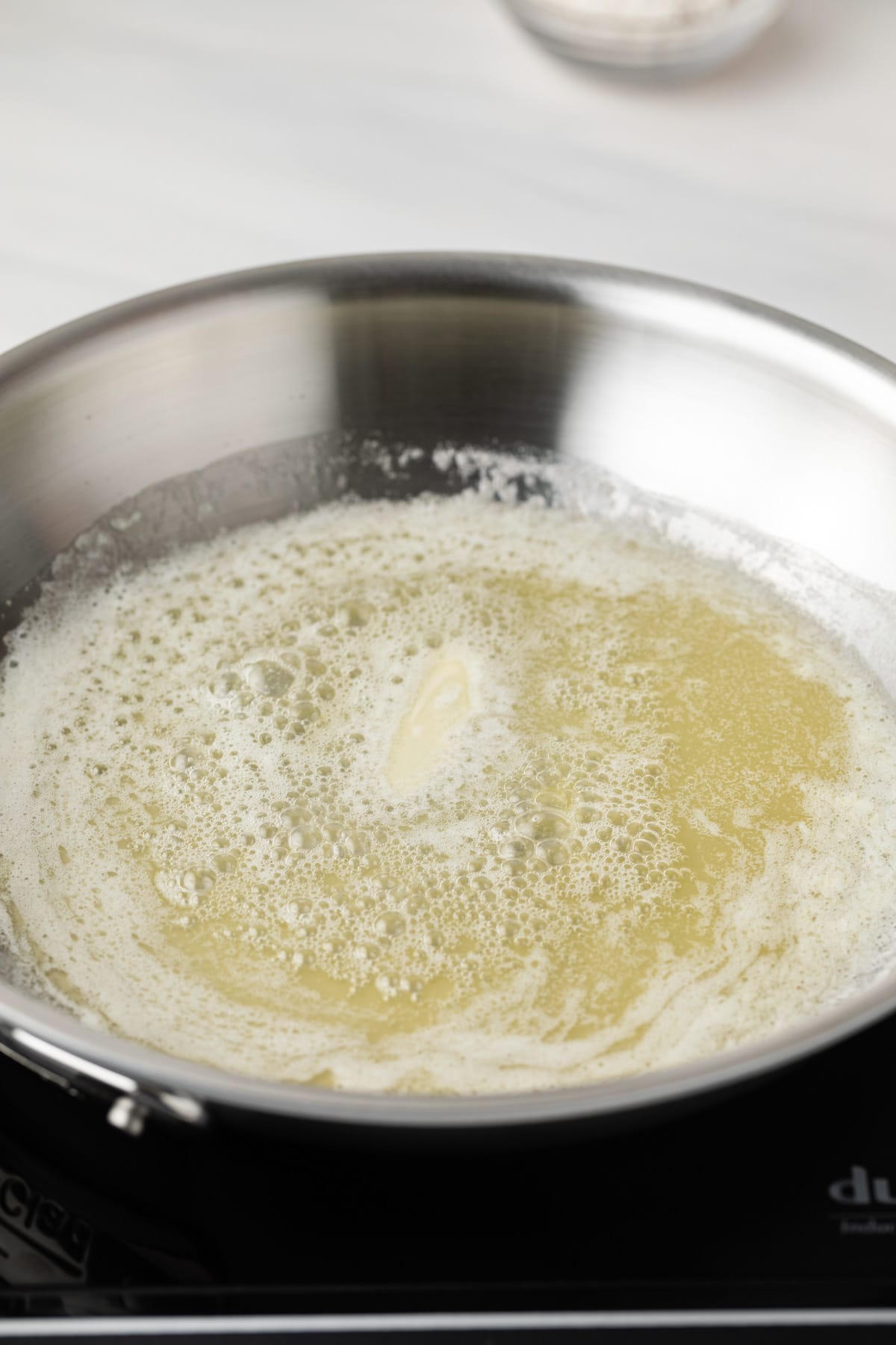 Melted butter in pan.