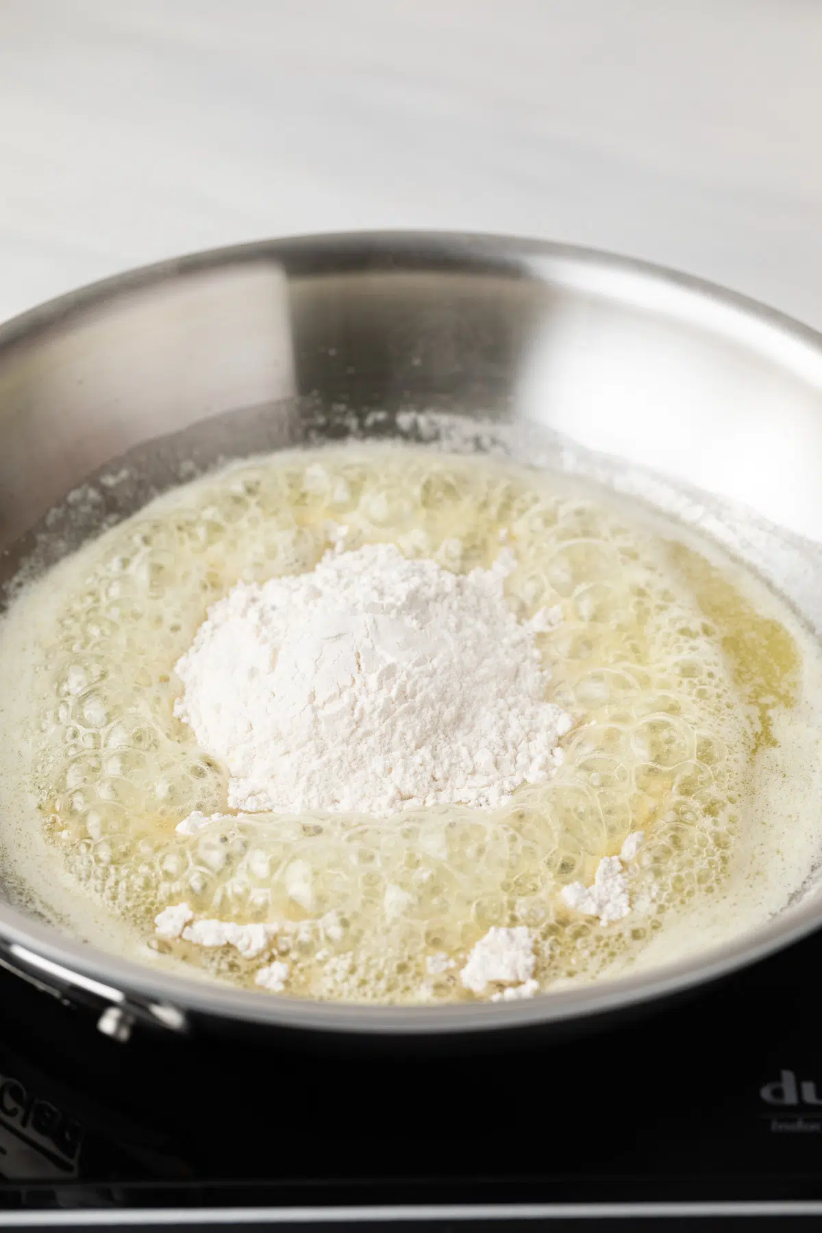 Flour in melted butter in pan.