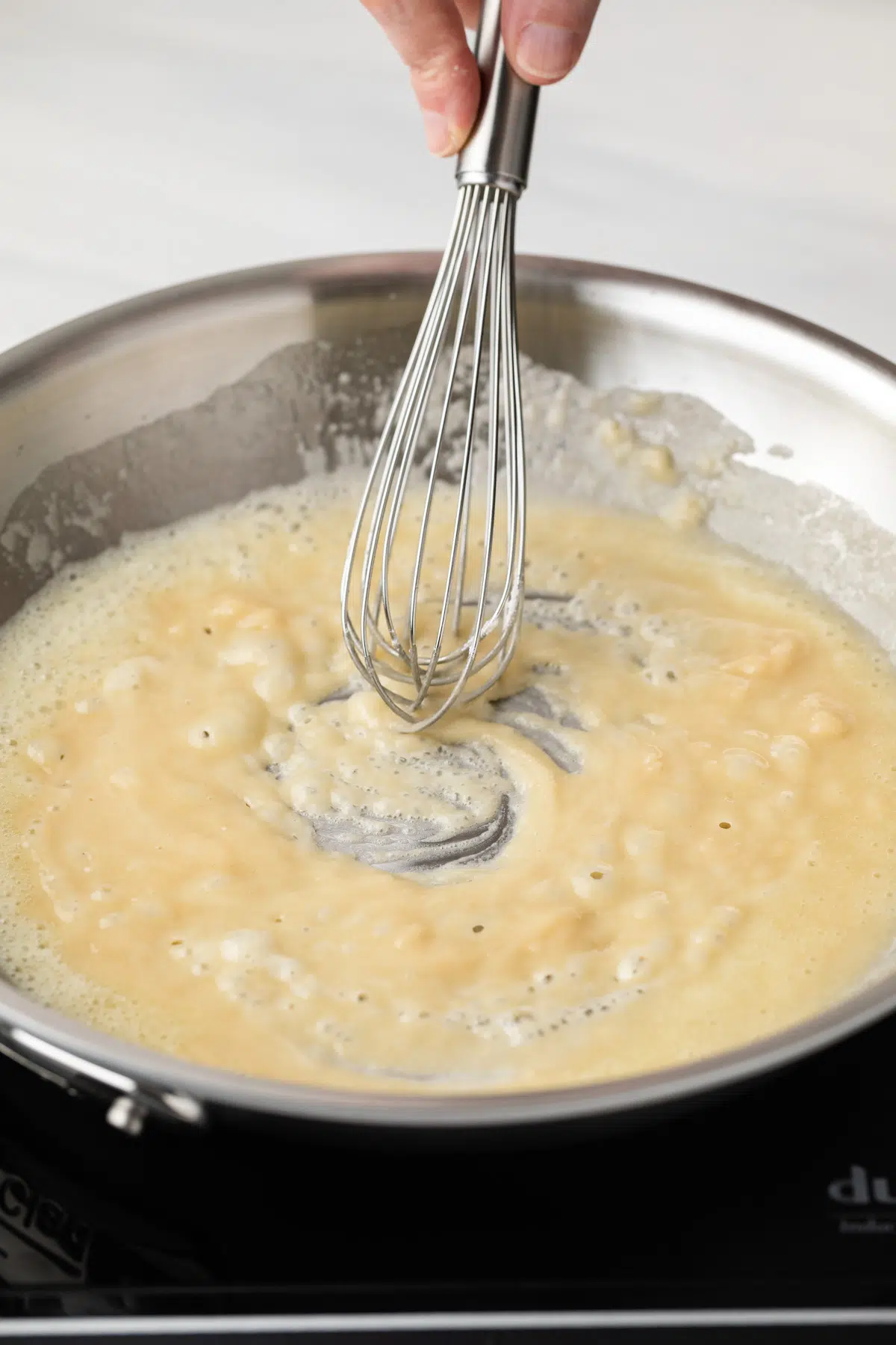 Whisking roux in pan.