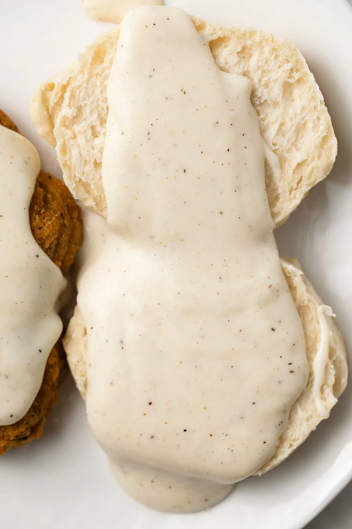 Country white gravy over biscuits and fried steak.