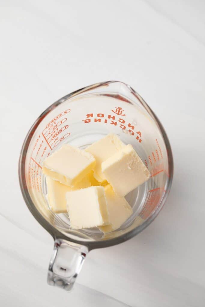 Cubes of butter in a liquid measuring cup.