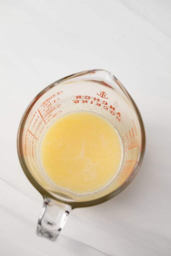 Melted butter in a liquid measuring cup.