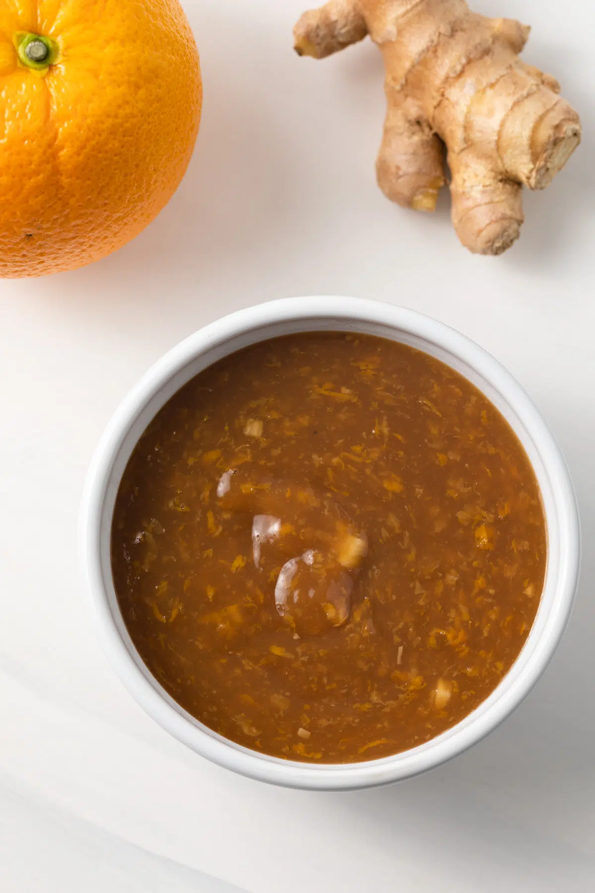 Orange ginger sauce in white bowl.