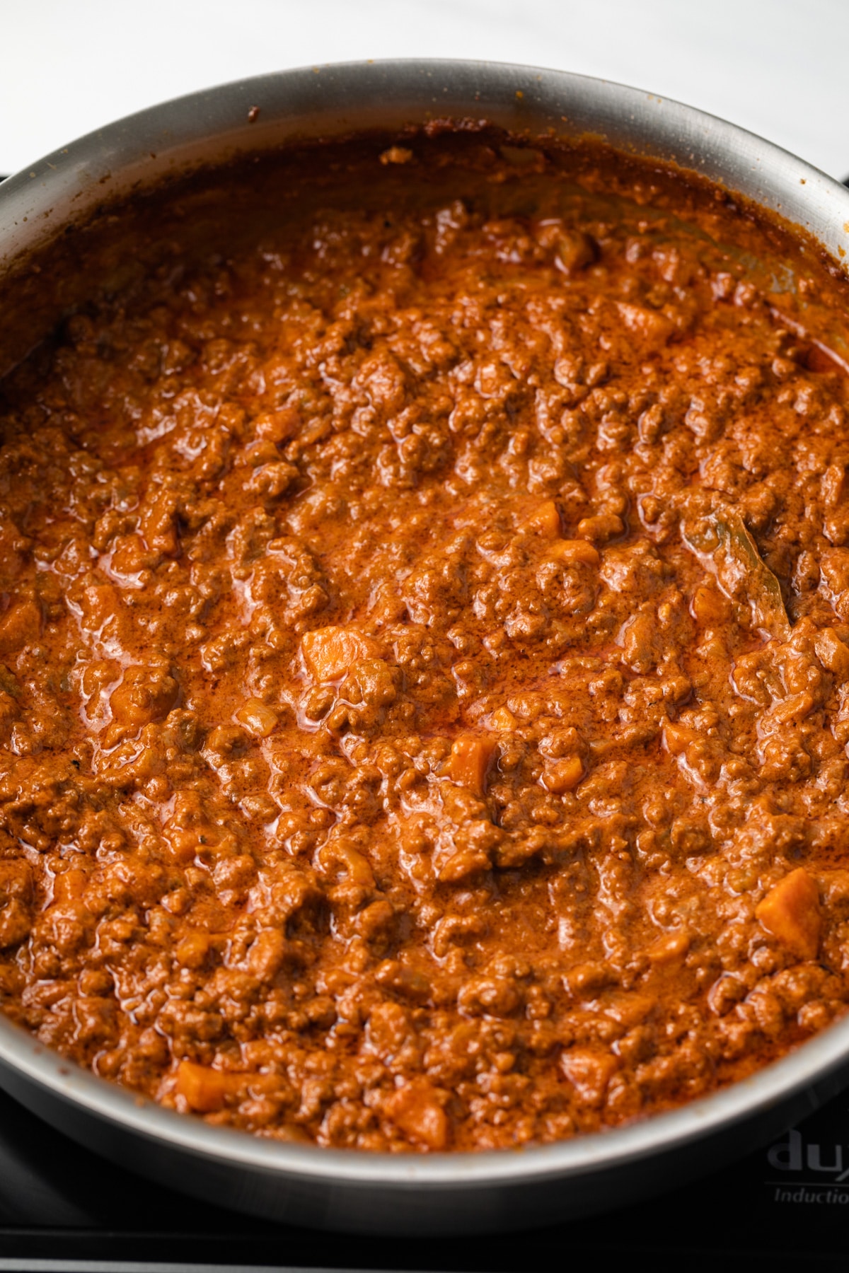 Bolognese meat sauce in saucepan.