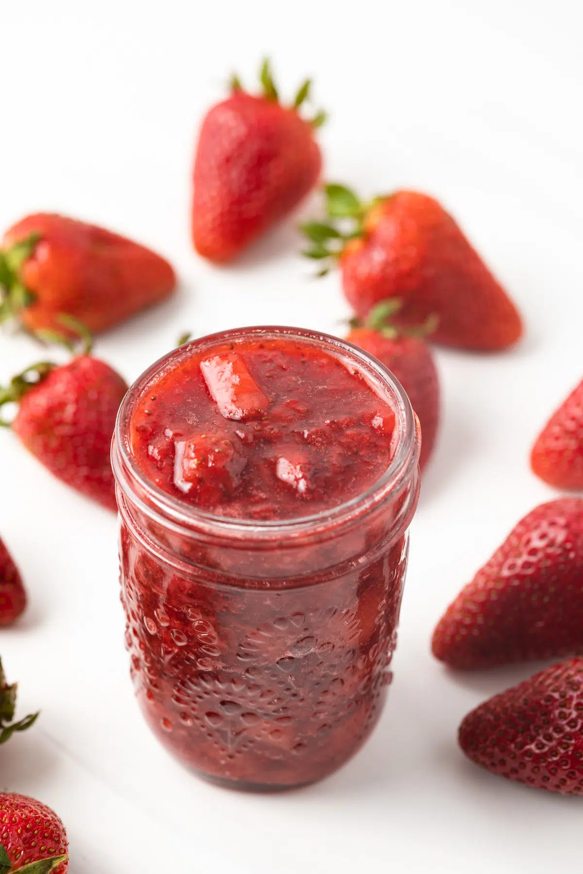 High angled view of strawberry sauce in a jar.