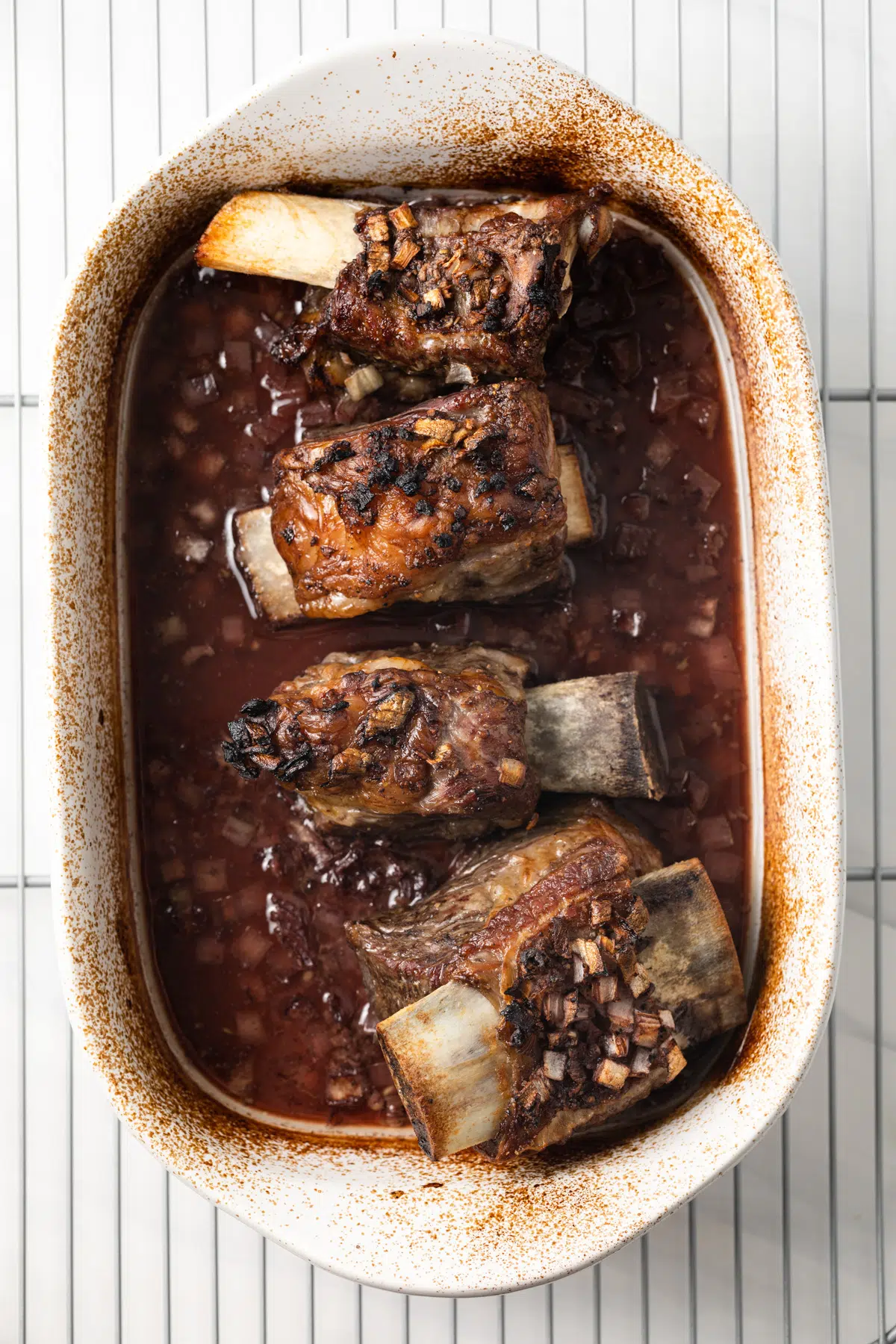 Cooked beef short ribs in pan.