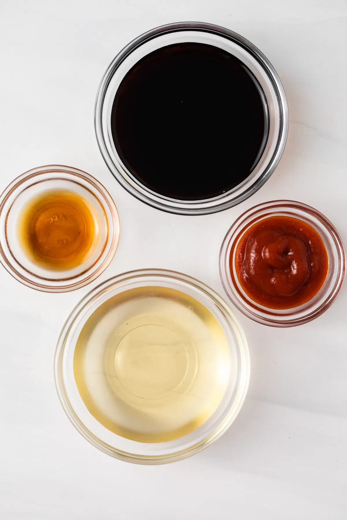 Dim sum dipping sauce ingredients in glass bowls.