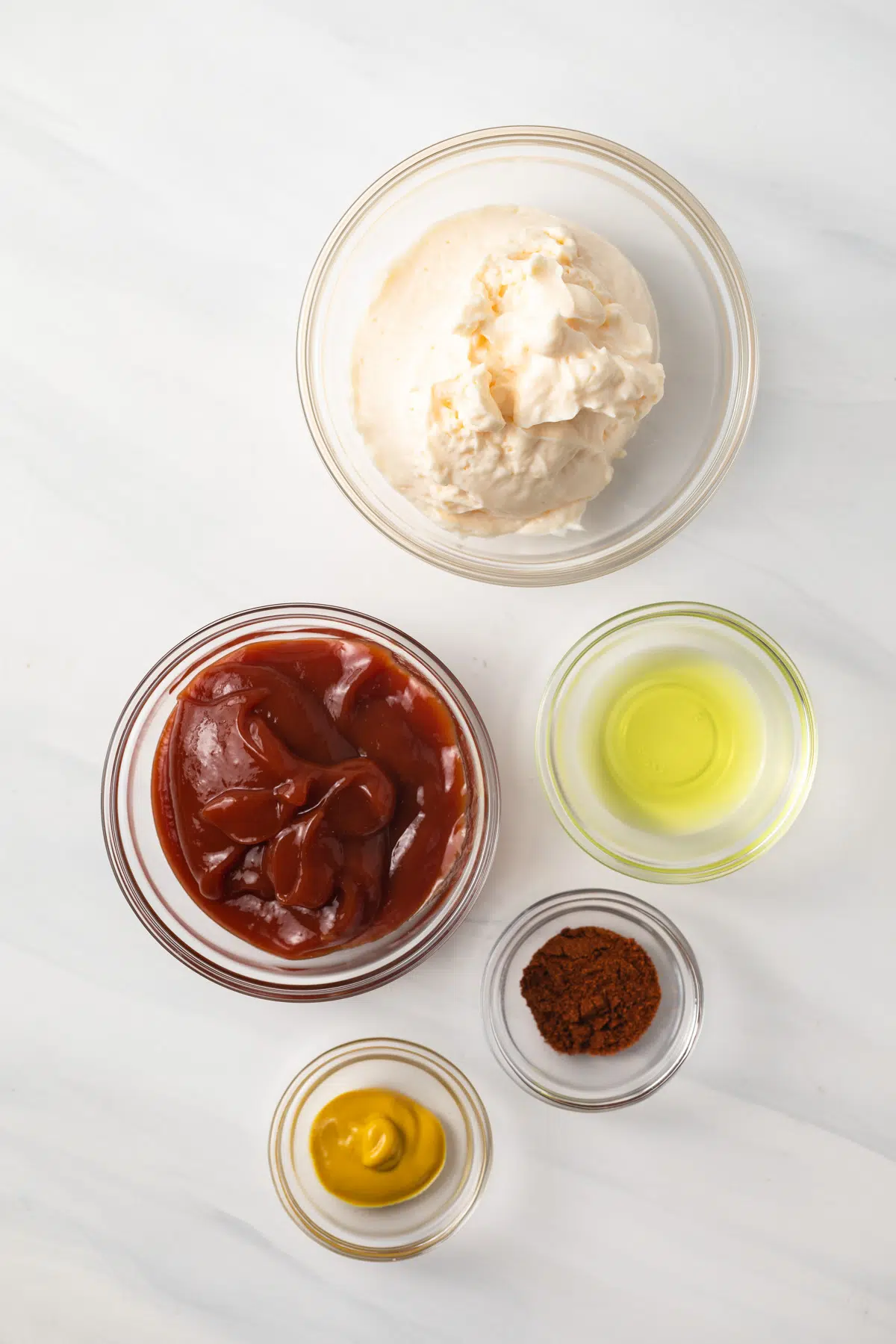 Ingredients for French fry sauce in glass bowls.