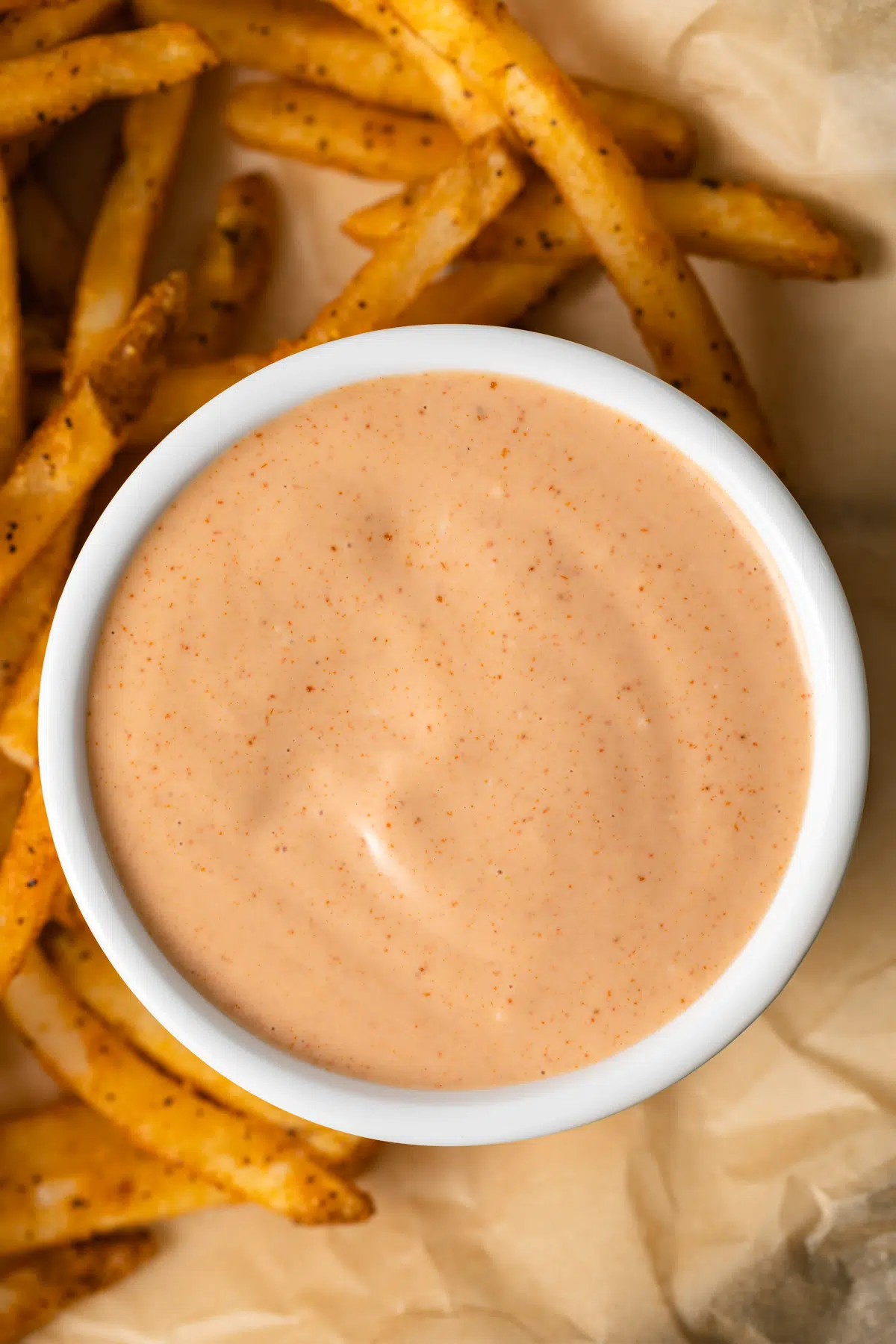 Close up of French fry sauce in white ramekin.