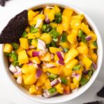 Bowl of peach mango salsa with tortilla chips.