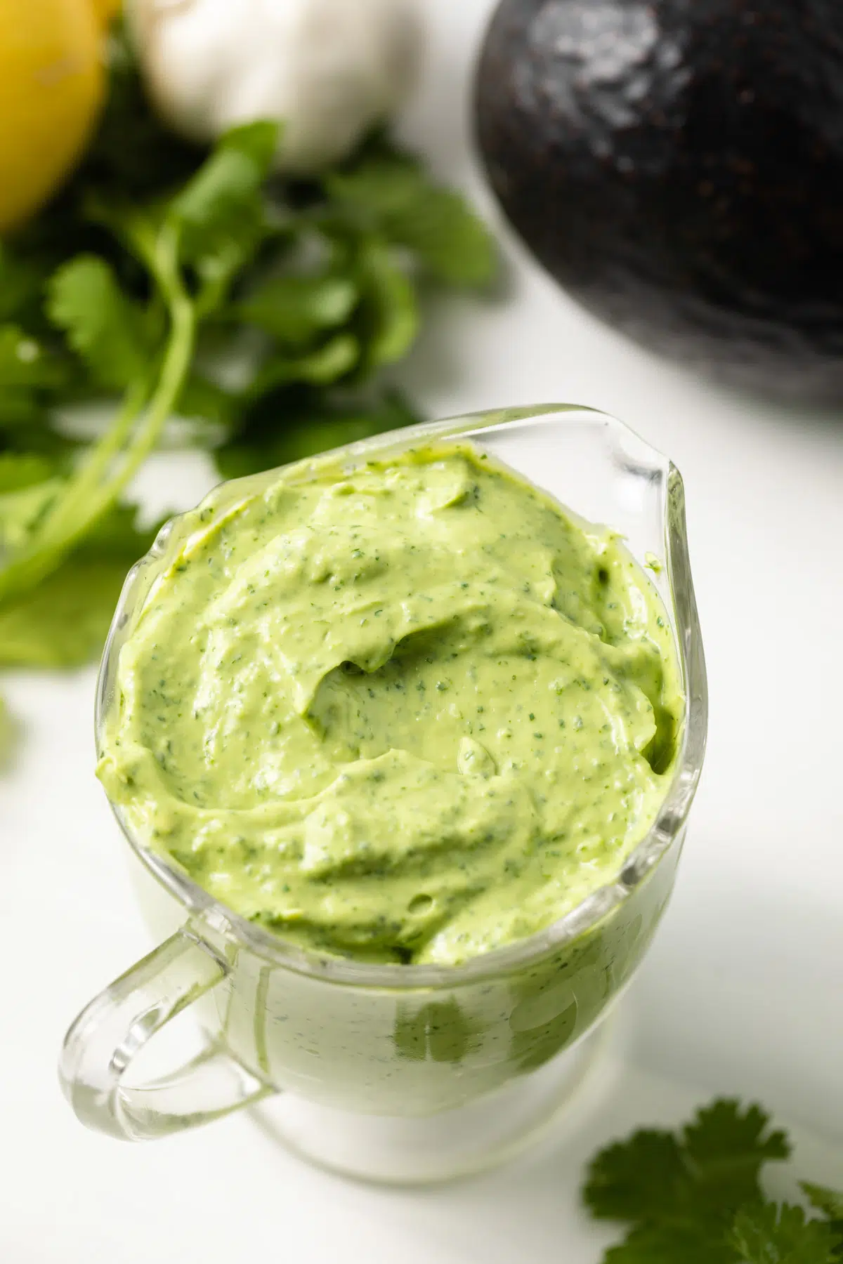 Creamy avocado cilantro dressing in a glass jar.