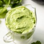 Creamy avocado cilantro dressing in a glass jar.