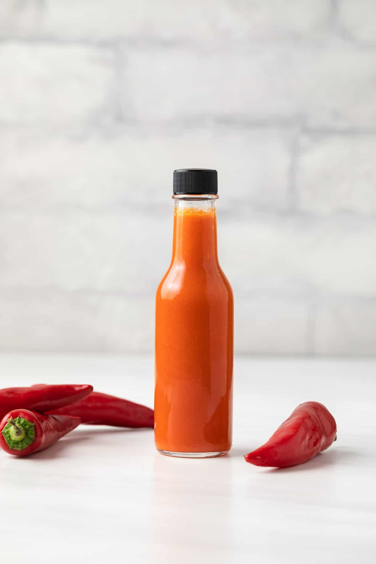 Cayenne pepper hot sauce in a glass jar.