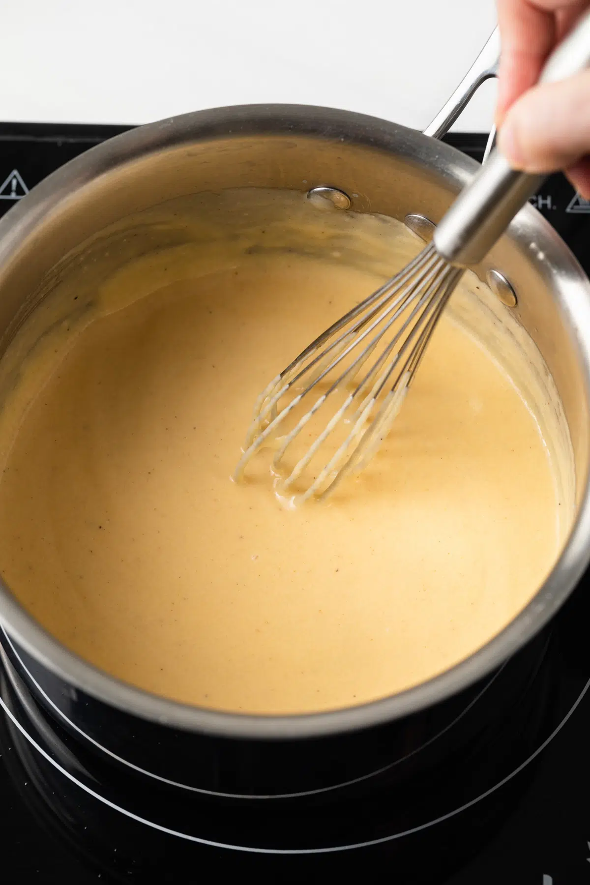 Cheese sauce in a saucepan.