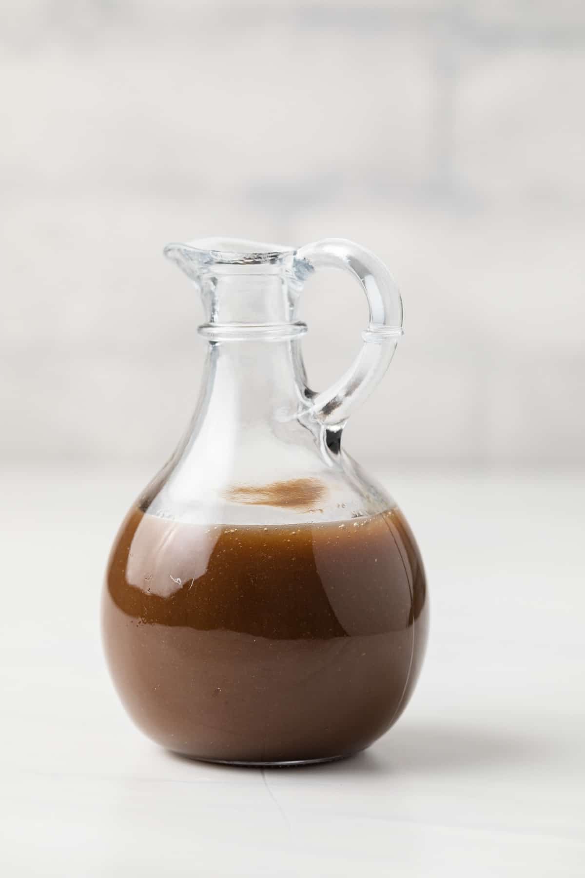 Honey Balsamic Vinaigrette in a small glass jug.