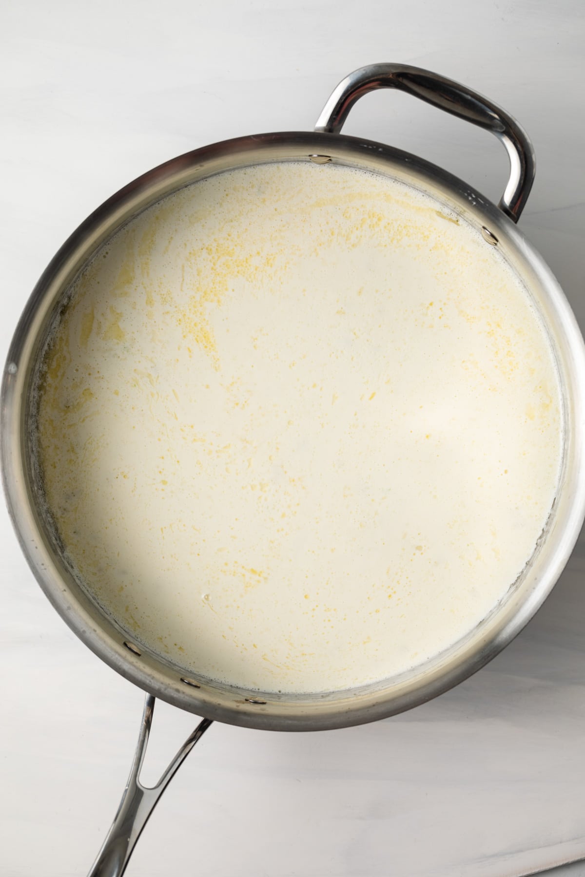 Cream with butter and garlic in a skillet.