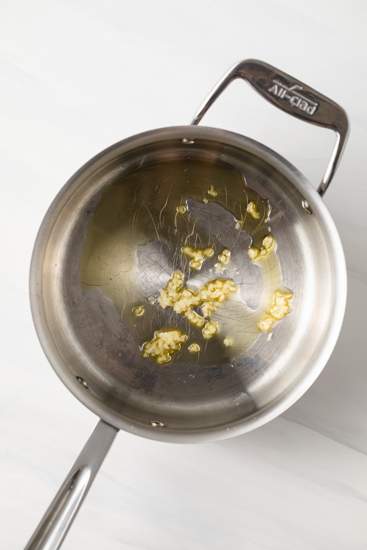Garlic and oil in a saucepan.