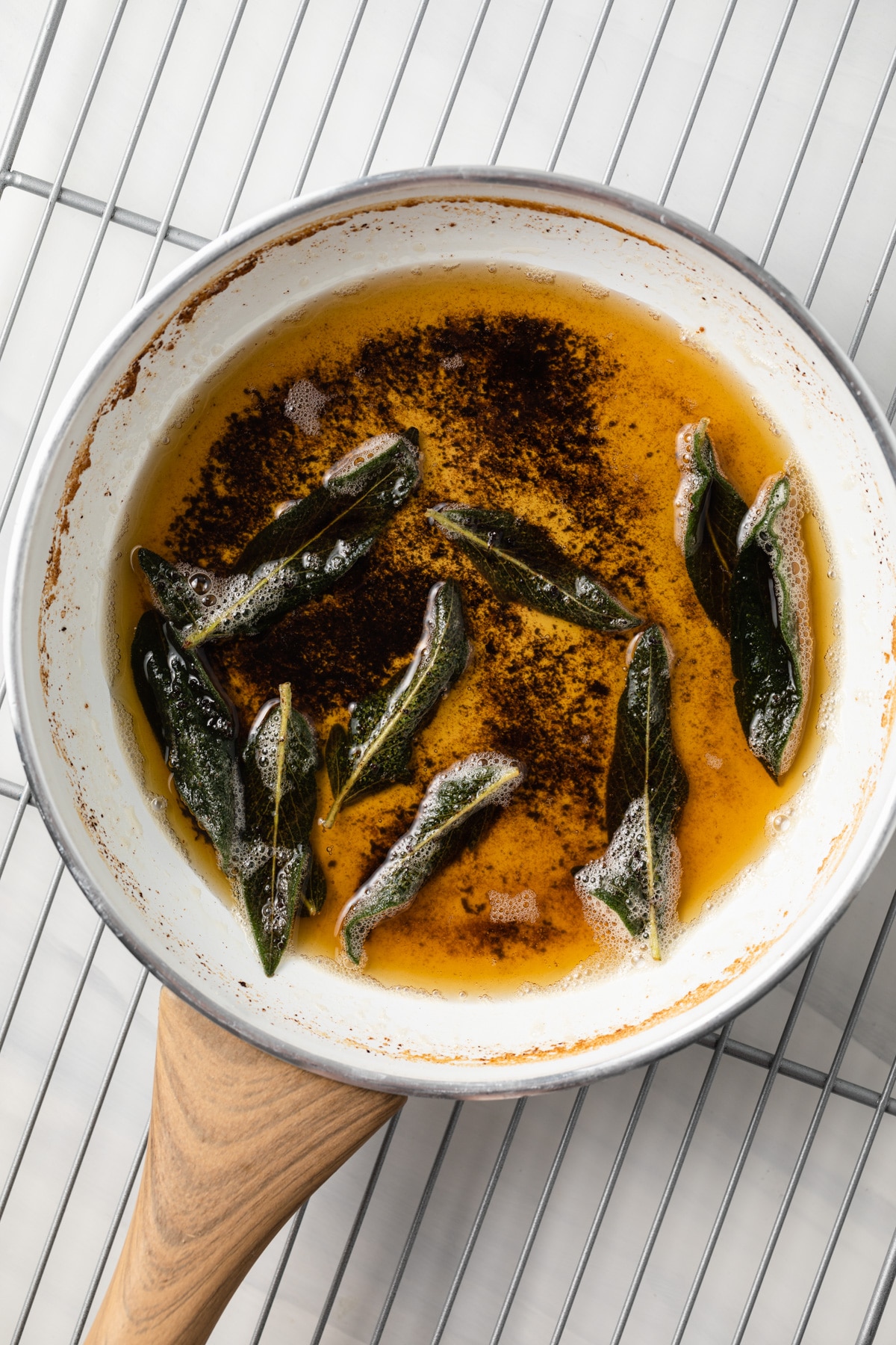 Sage butter sauce in a white fry pan.