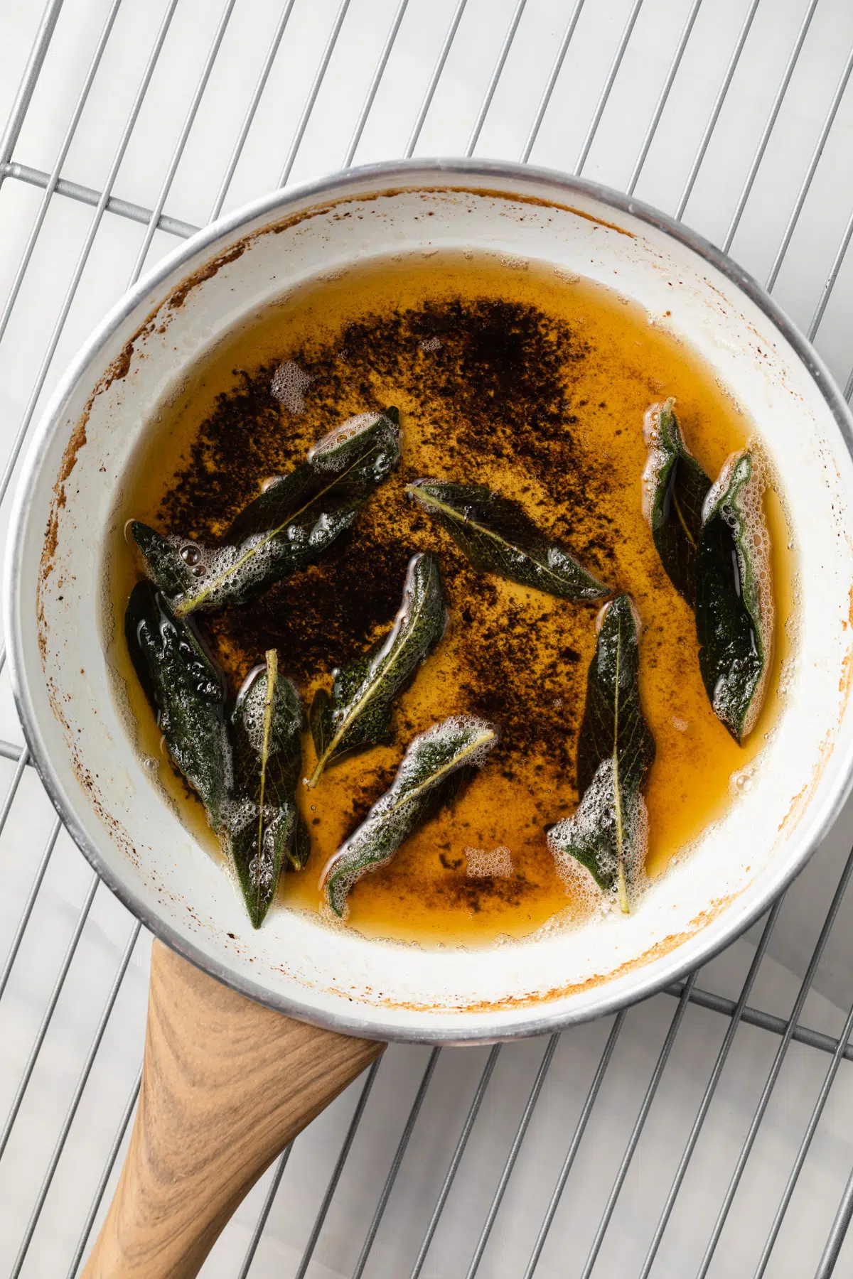 Sage butter sauce in a white fry pan.