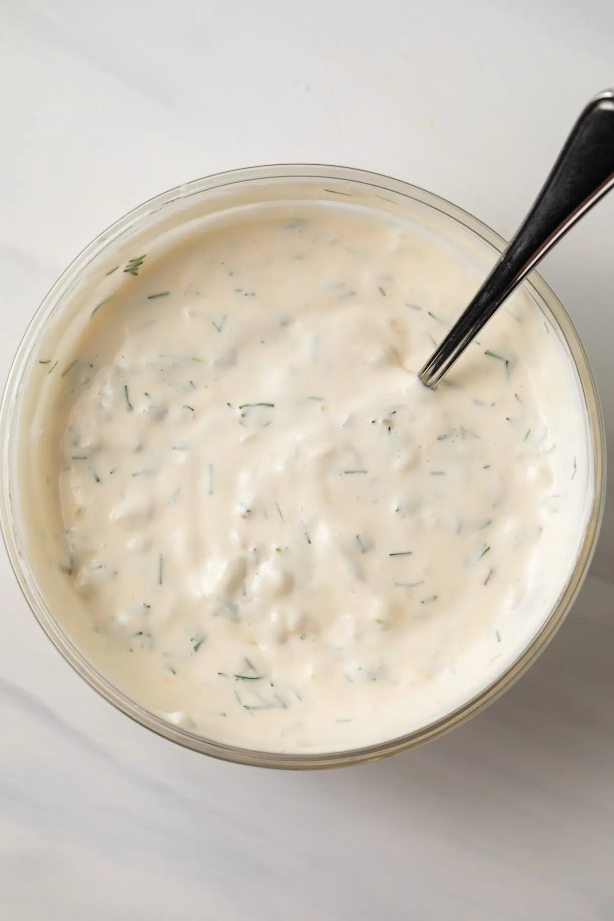 Tartar sauce in a glass mixing bowl.