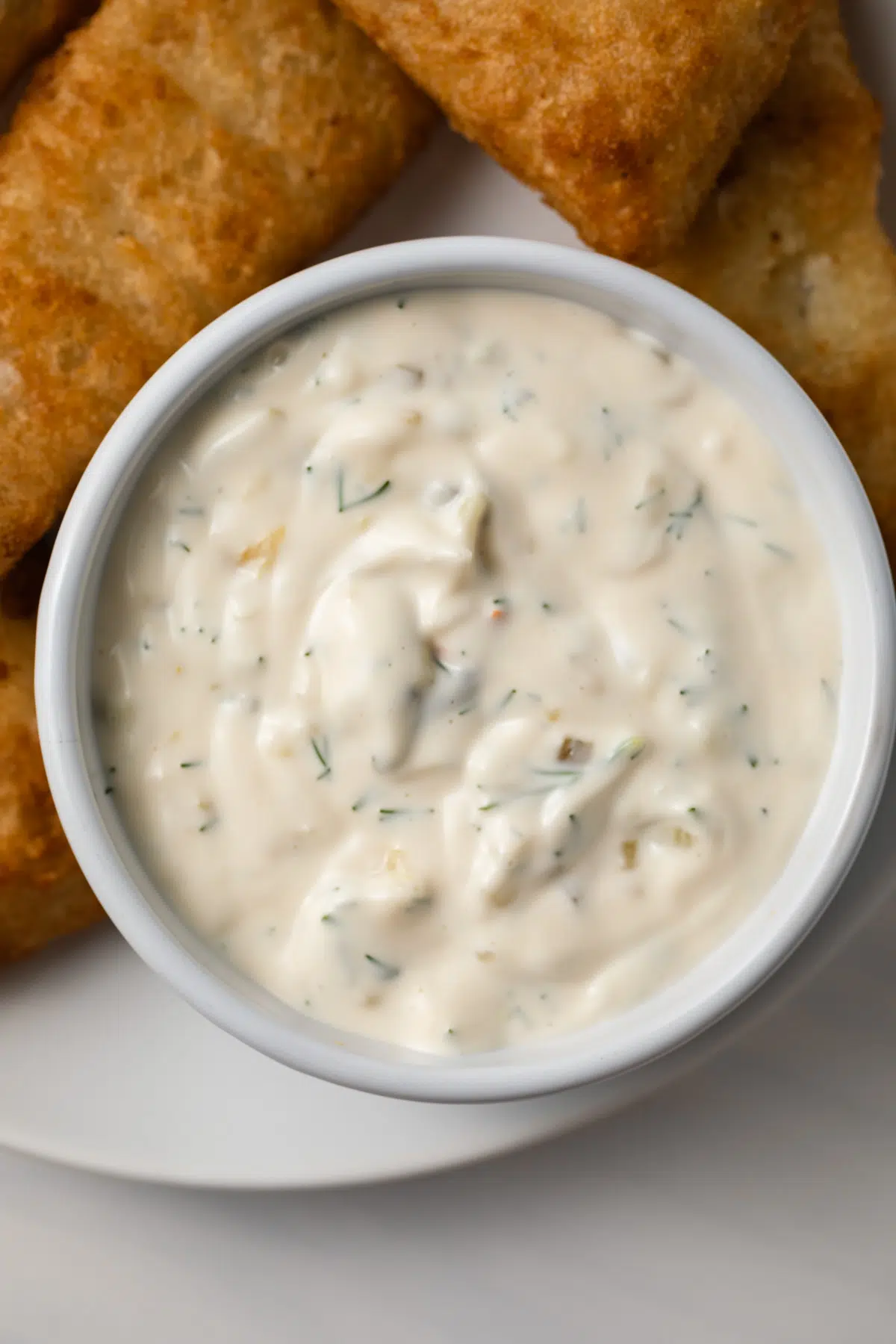 Close up of tartar sauce in white bowl.