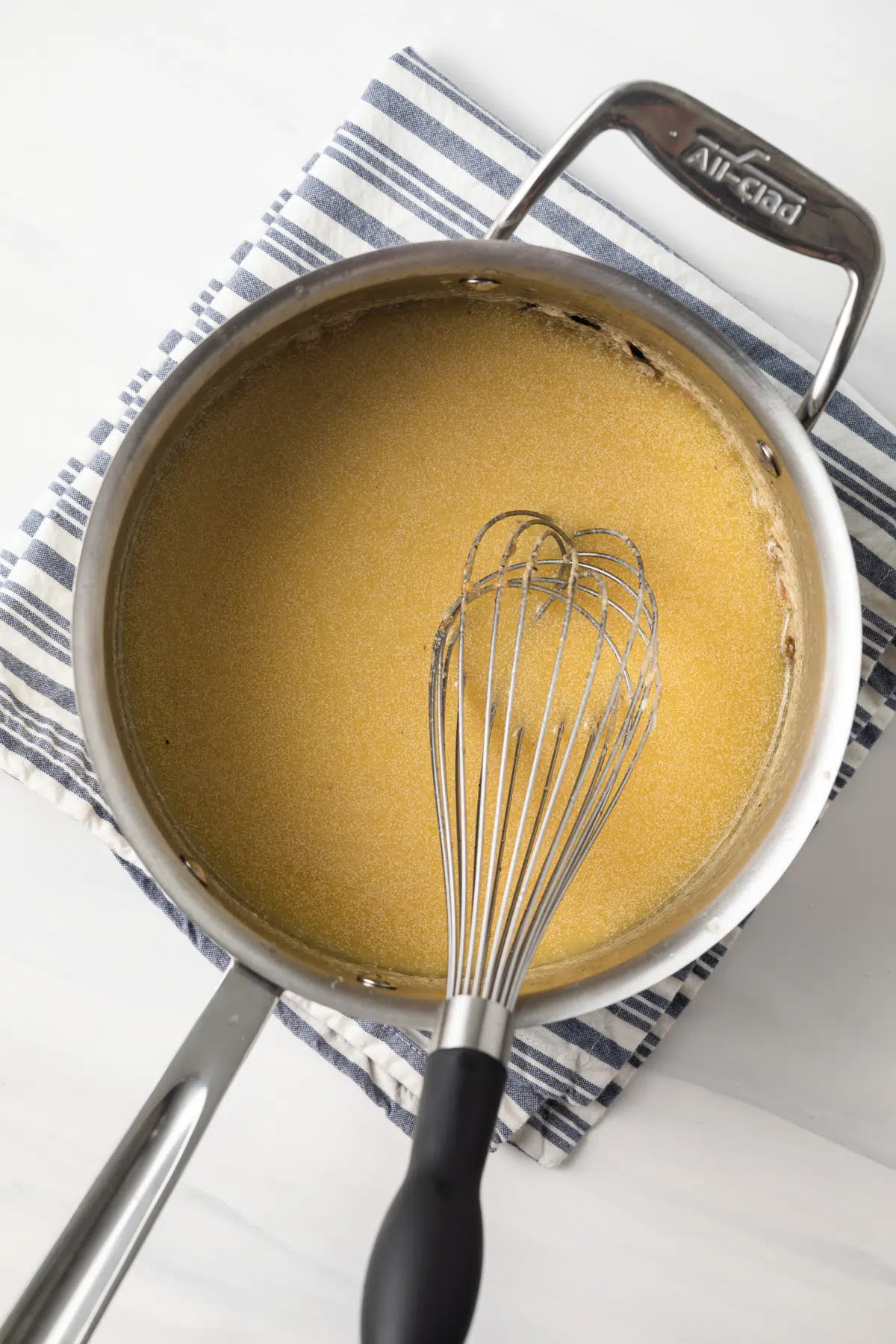 Beurre blanc sauce in saucepan.