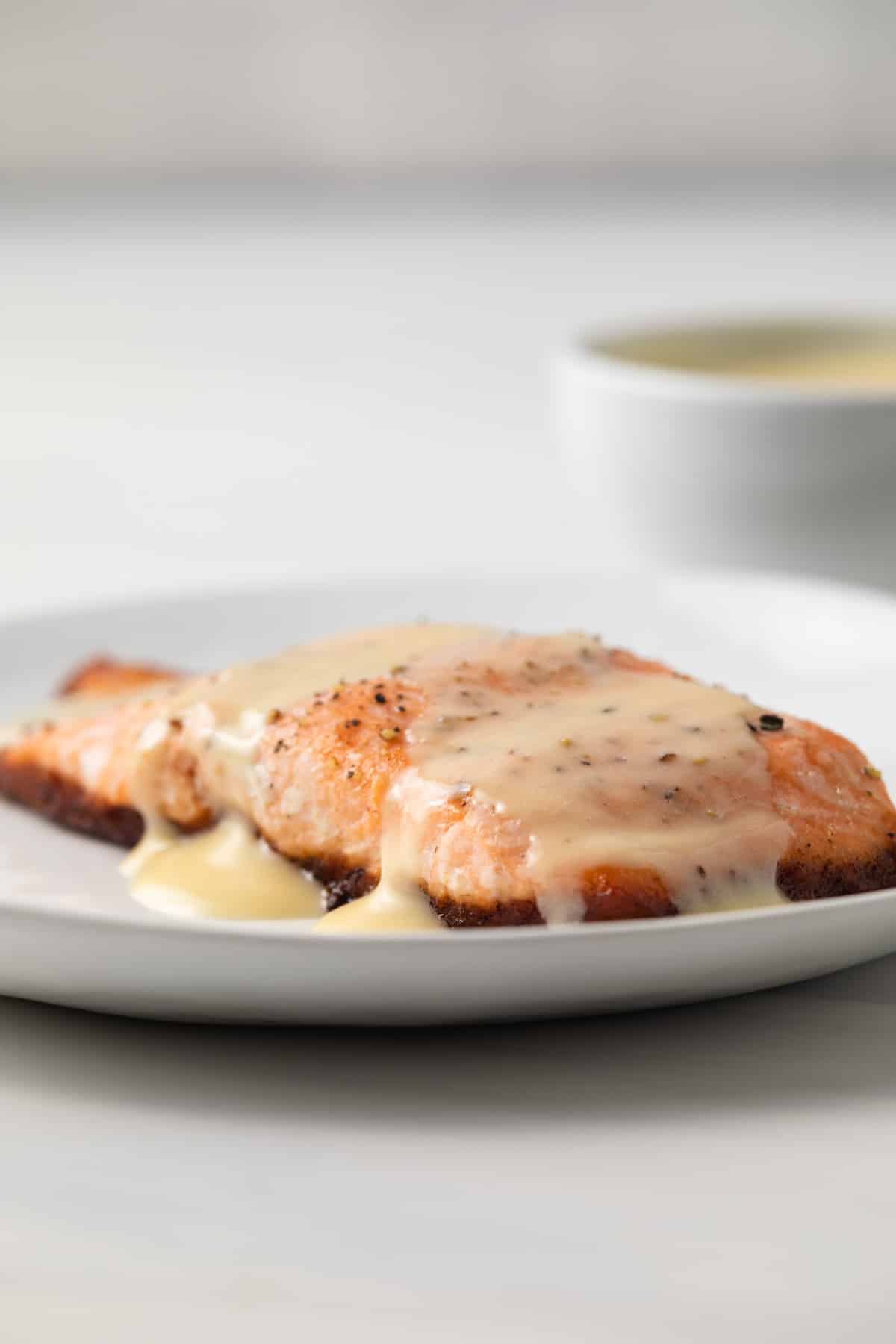 Salmon topped with beurre blanc sauce.