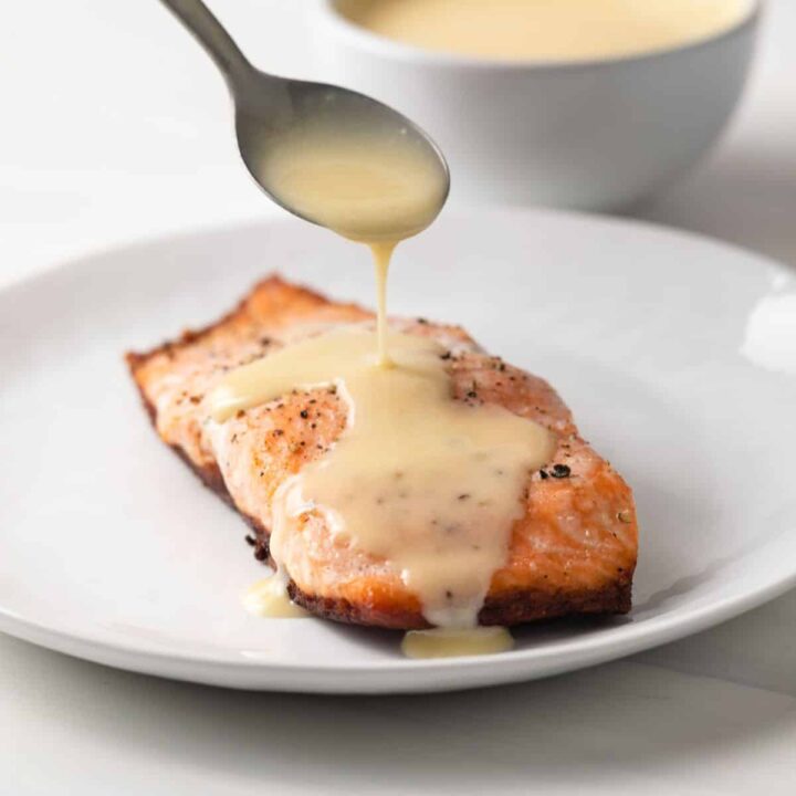 Beurre blanc sauce spooned over salmon.