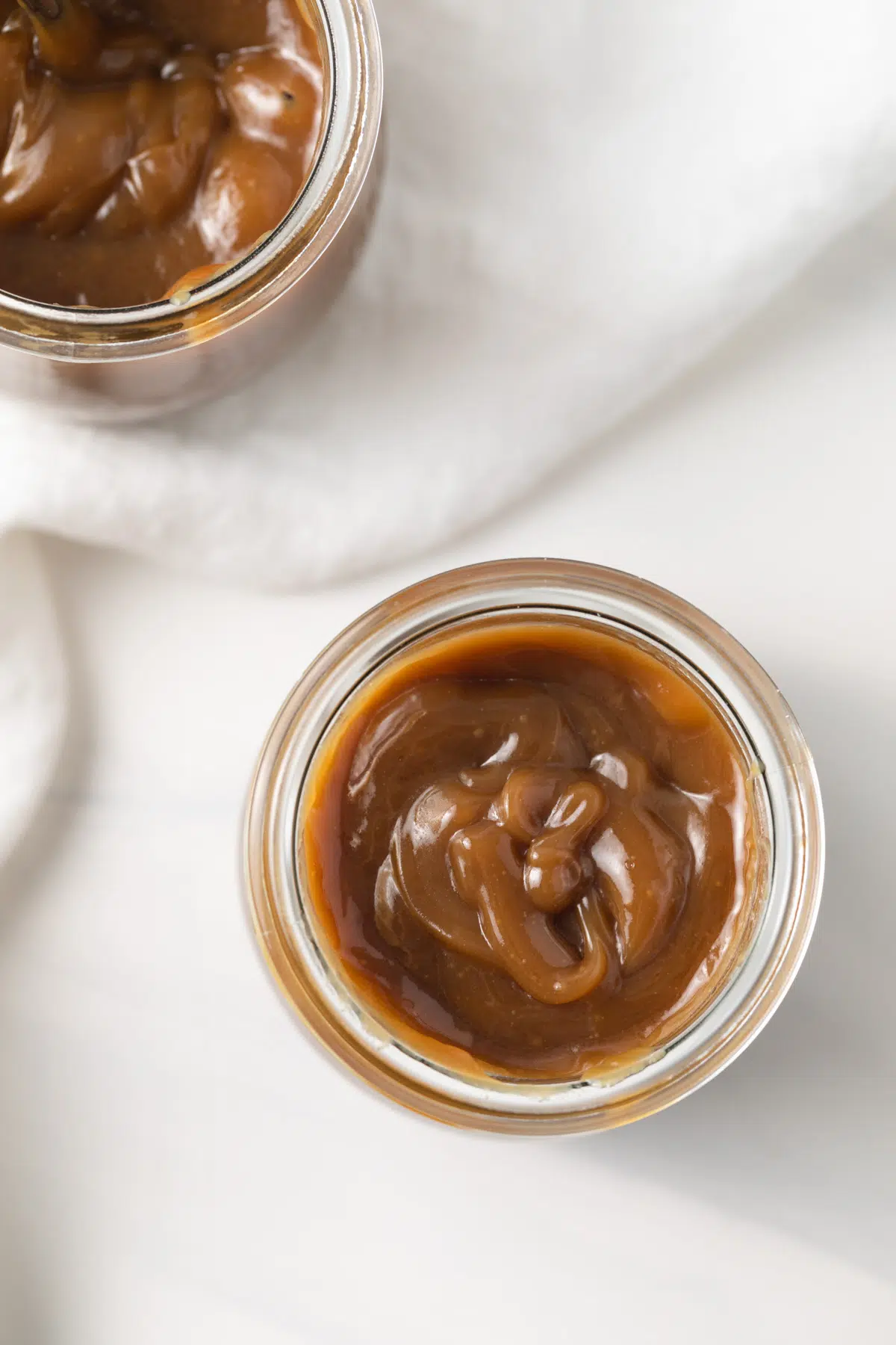 Overhead of butterscotch sauce in a jar.